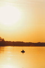 Silhouette of fisherman during sunset