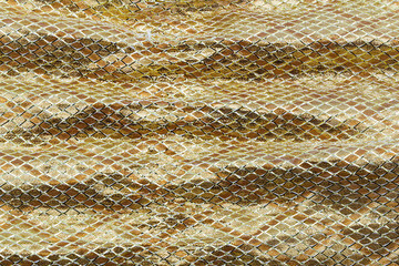Holiday background image of gold sparkly mesh ribbon on metallic fabric with copy space. Macro with extremely shallow dof.
