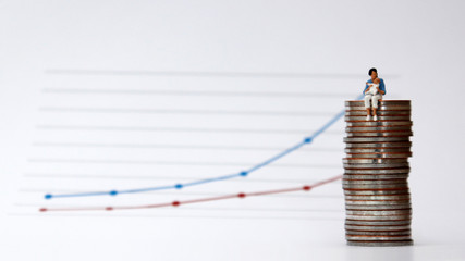 Linear graph with a miniature woman sitting in a pile of coins holding a baby. The concept of wage...