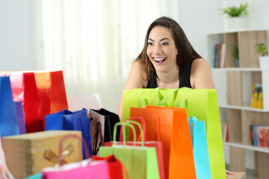 Crazy shopper looking at several shopping bags