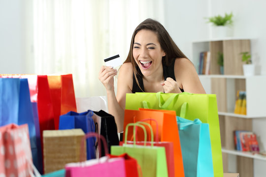 Excited shopper looking at multiple purchases