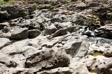 Woman enjoying the view of a rocky creek.