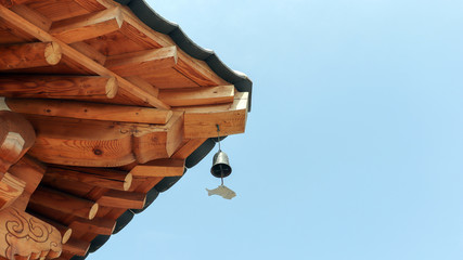 Wind-bell with metal fish at the eaves of Korean traditional houses.