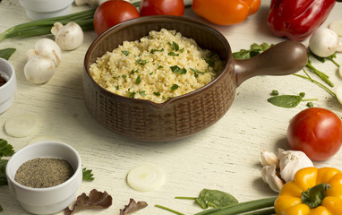 Bulgur in plate on wooden table. Traditional middle eastern or arab dish. Top view. vegetarian...
