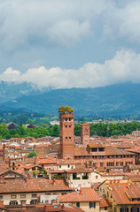 Lucca old  historic center skyline with medieval towers and clouds above