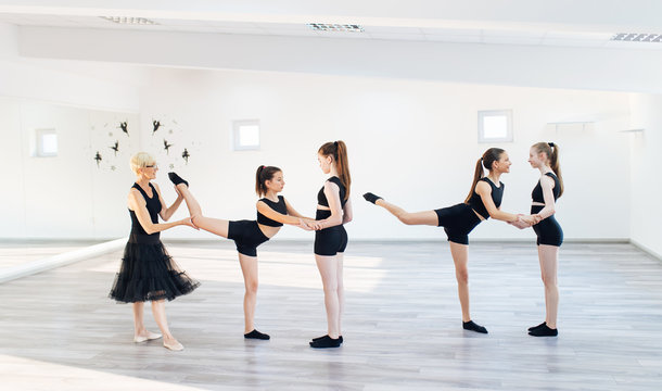 The group of beautiful girls practicing modern ballet dance.