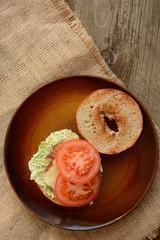fresh  sandwiches with meat, cheese, bacon, tomatoes, lettuce, cucumbers and onions on wooden background 