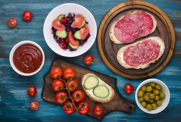 plate of sandwiches with salami and salad