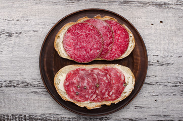 plate with sandwiches on a wooden background