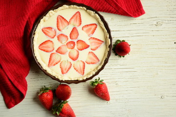 Strawberry pie on wooden board with plate of srawberry. Fruit tarts with sweet fresh strawberries. Freshly baked cake, biscuit.  
