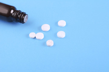 Close up of heap of pills with pill bottle