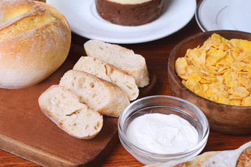 Close up of toast, coffee and bowl with cereals