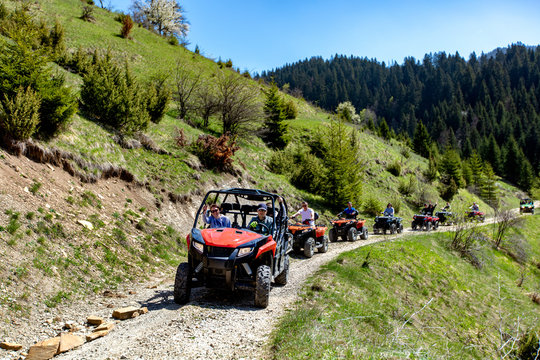 A tour group travels on ATVs and UTVs on the mountains