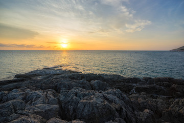 Beautiful sunset over calm sea with limestone rocks mountain at Promthep Cape, Promthep Cape is one of the most beautiful locations in Thailand, It’s a spectacular place to visit.