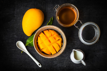 Yellow Mango peel In the cup And honey and coconut milk