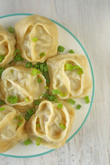 dumplings. Homemade  manti  in a round plate on shabby chic background . Traditional  manti with meat 