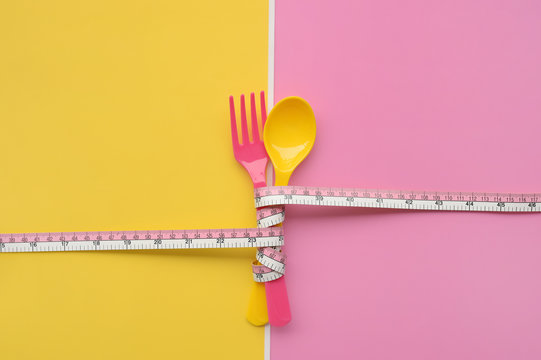 close up of spoon tied with tape measure for background