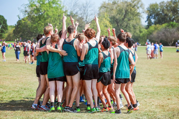 Boys on cross country team in a huddle