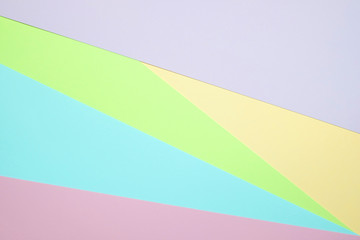 Fashionable  pastel colored paper flat lay top view, geometric background texture, pink, purple, yellow, beige, green and blue.
