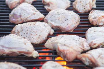 raw chicken on a charcoal grill