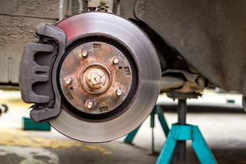 brake discs on the machine with the removed wheels on the jacks. wheel replacements