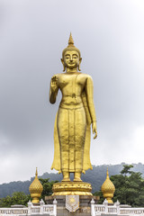 Obraz premium Phra Buddha Mongkol Maharaj tallest Golden Standing Buddha at Hat Yai Municipal Park, Hat Yai Thailand