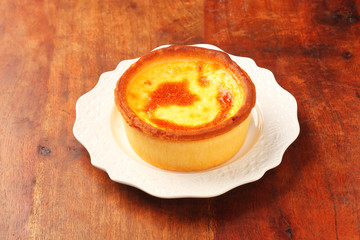 Baked egg tart on old wood background.   