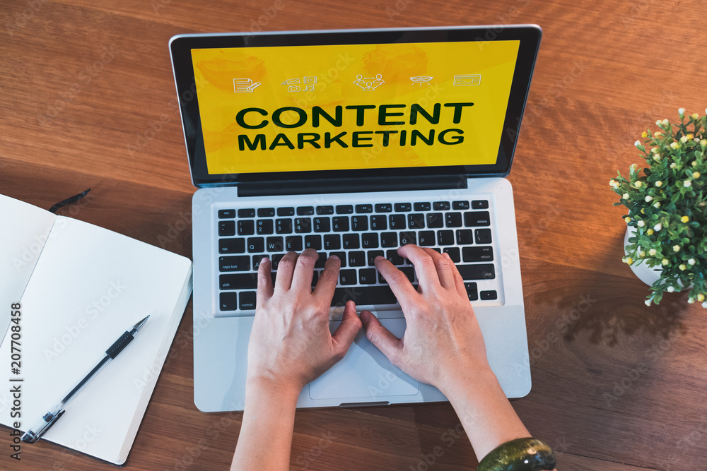 Poster Top view hand type on laptop keyboard with content marketing on laptop  screen and plant on table at home.digital technology business.influencer and blogger tool for engage viewer.