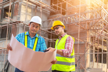 A construction worker control a pouring concrete pump on construction site.