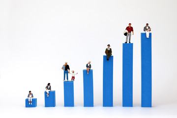 The miniature people on the bars of the blue bar graph on a white background.