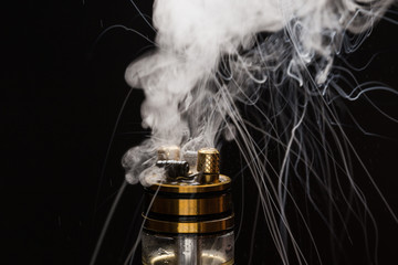 Vape close-up with smoke on a black background