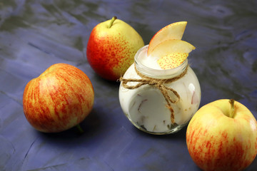 Food. Milk product. Creamy yogurt in a jar with fresh juicy fruit pears and apples for a healthy diet.