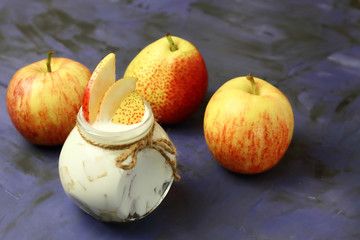 Food. Milk product. Creamy yogurt in a jar with fresh juicy fruit pears and apples for a healthy diet.
