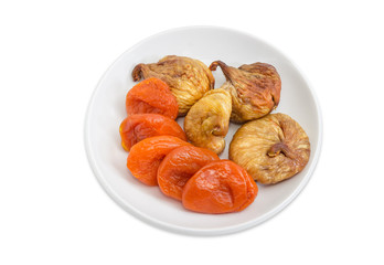 Dried figs and apricots on the white saucer