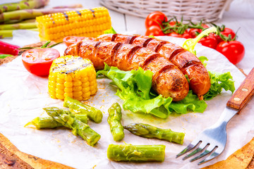 grilled krakauer sausage with boiled corn and green salad