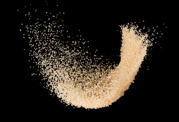 Fototapeta na wymiar Brown sugar splash isolated on black background ,throwing freeze stop motion element food and drink object design