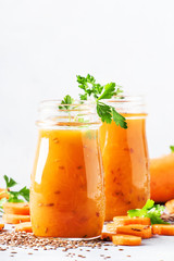 Carrot smoothie or juice with linen seeds, healthy and useful drink, gray background, selective focus
