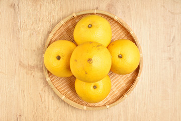 Pile of stacked  navel oranges in a bambo basket  