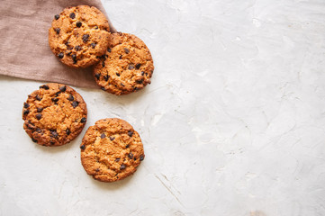 Homemade chocolate chip cookies on a white stone background. Top view and copy space.