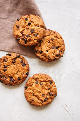 Homemade chocolate chip cookies on a white stone background. Top view and copy space.