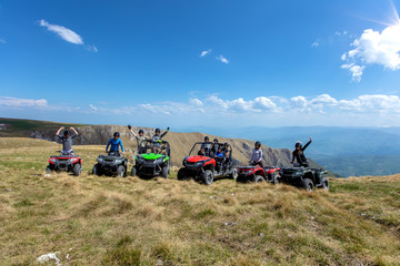 Friends driving off-road with quad bike or ATV and UTV vehicles - obrazy, fototapety, plakaty