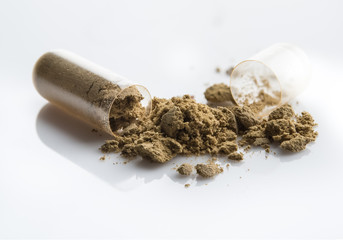 Herbal medicine powder in capsule on white background