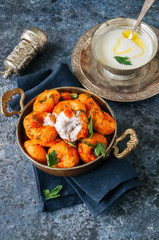 Traditional Turkish food - fellah koftes, polpettes from bulgur and semolina in tomato sauce with parsley and ayran. Middle eastern food concept.