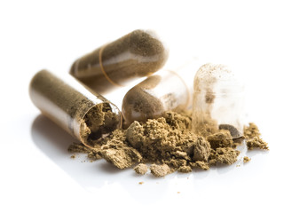 Herbal medicine powder in capsule on white background