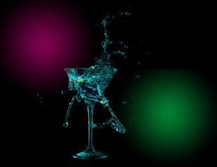 colorful cocktail in glass with splashes on dark background. Party club entertainment. Mixed light