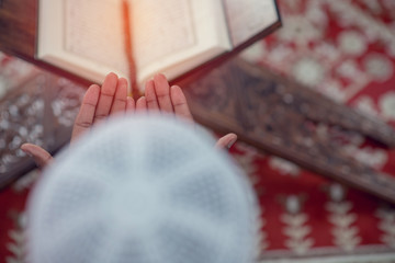 Top viewv of African Muslim Man Making Traditional Prayer To God While Wearing A Traditional Cap Dishdasha