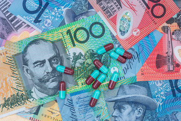 Fototapeta premium Colourful capsuled tablets on australia dollar banknotes