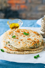 Indian flatbread - Herb stuffed paratha on a baking paper