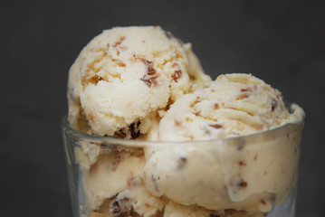Ice Cream Scoop in Glass Cup isolated over Gray background. homemade Dessert Icecream with Chocolate flakes