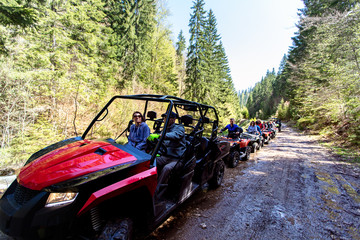 A tour group travels on ATVs and UTVs on the mountains © FS-Stock